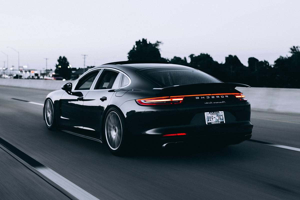sports car running black Porsche sedan automobile